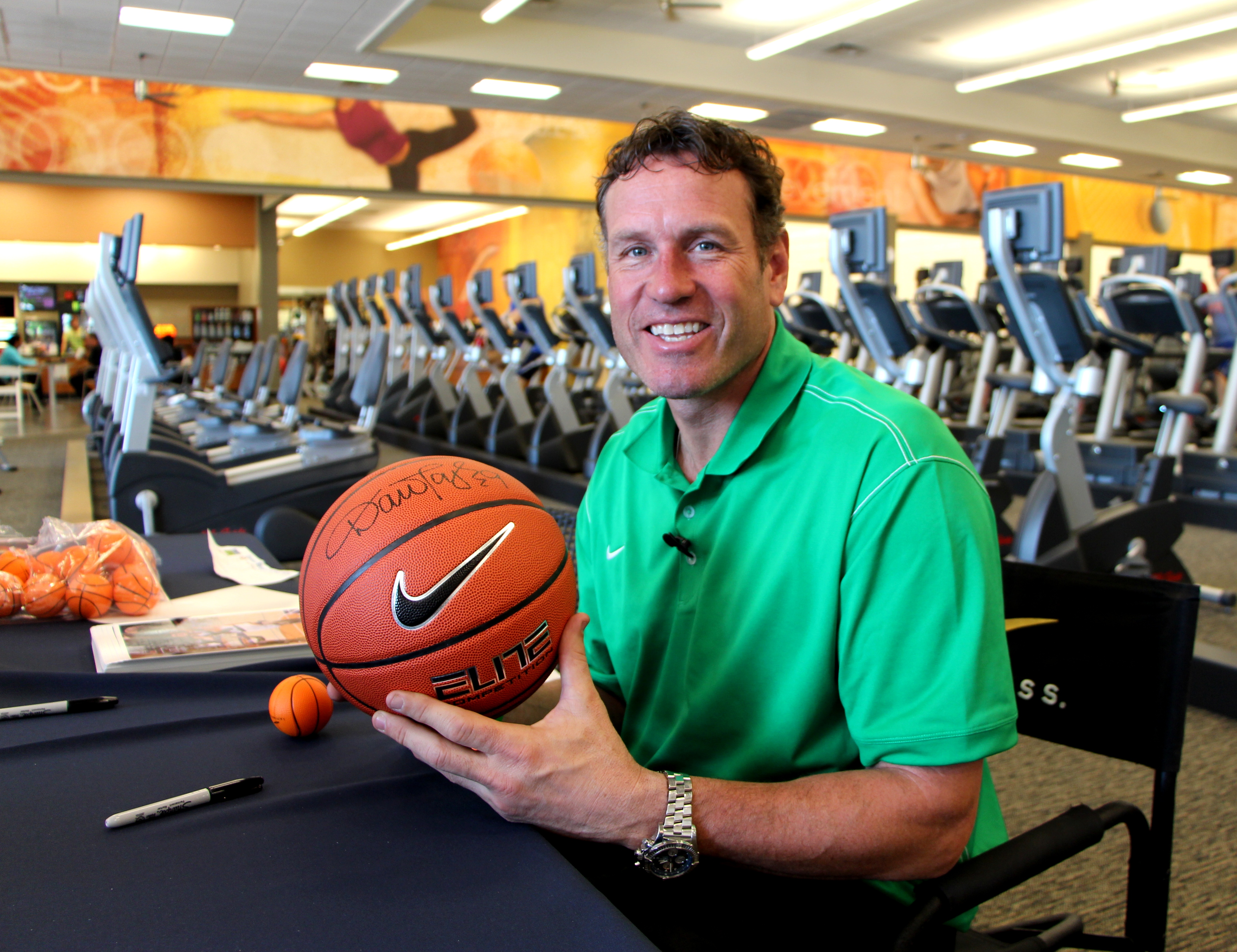 Phoenix Suns legend Dan Majerle autographs a basketball for the LIVING HEALTHY give away contest